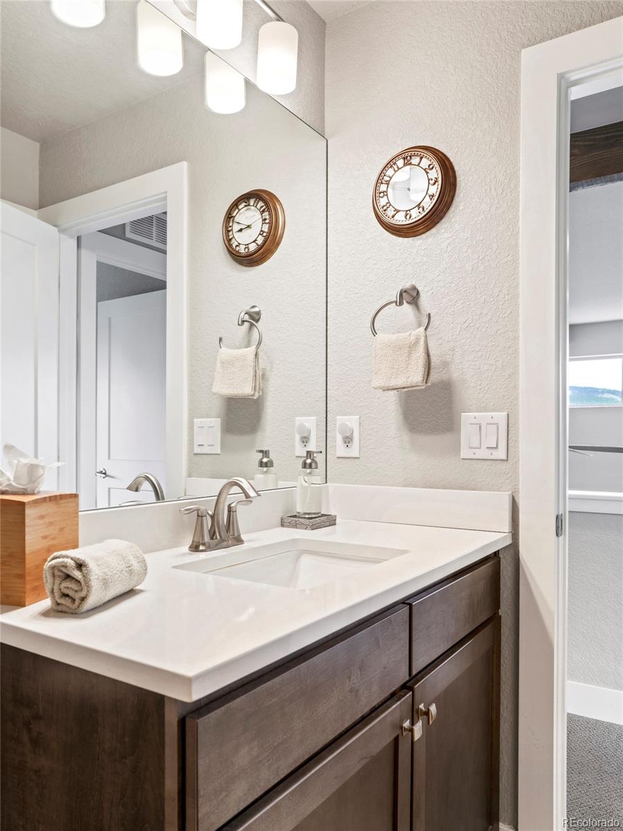 460 Elk Track Circle Granby, CO 80446 - Photo 20 of 26 a bathroom with a sink and a mirror