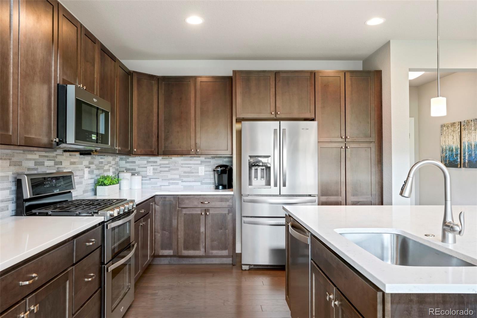 460 Elk Track Circle Granby, CO 80446 - Photo 8 of 26 a kitchen with kitchen island granite countertop a sink stainless steel appliances and cabinets