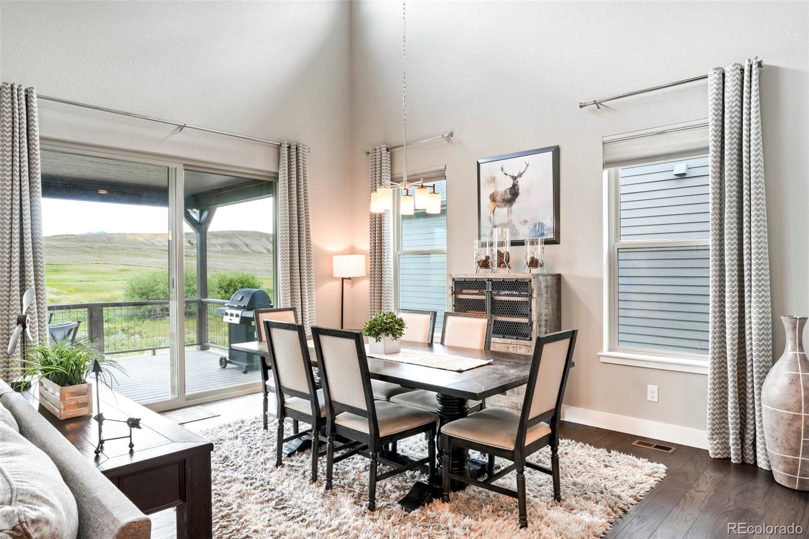 460 Elk Track Circle Granby, CO 80446 - Photo 10 of 26 a dining room with furniture large windows and wooden floor