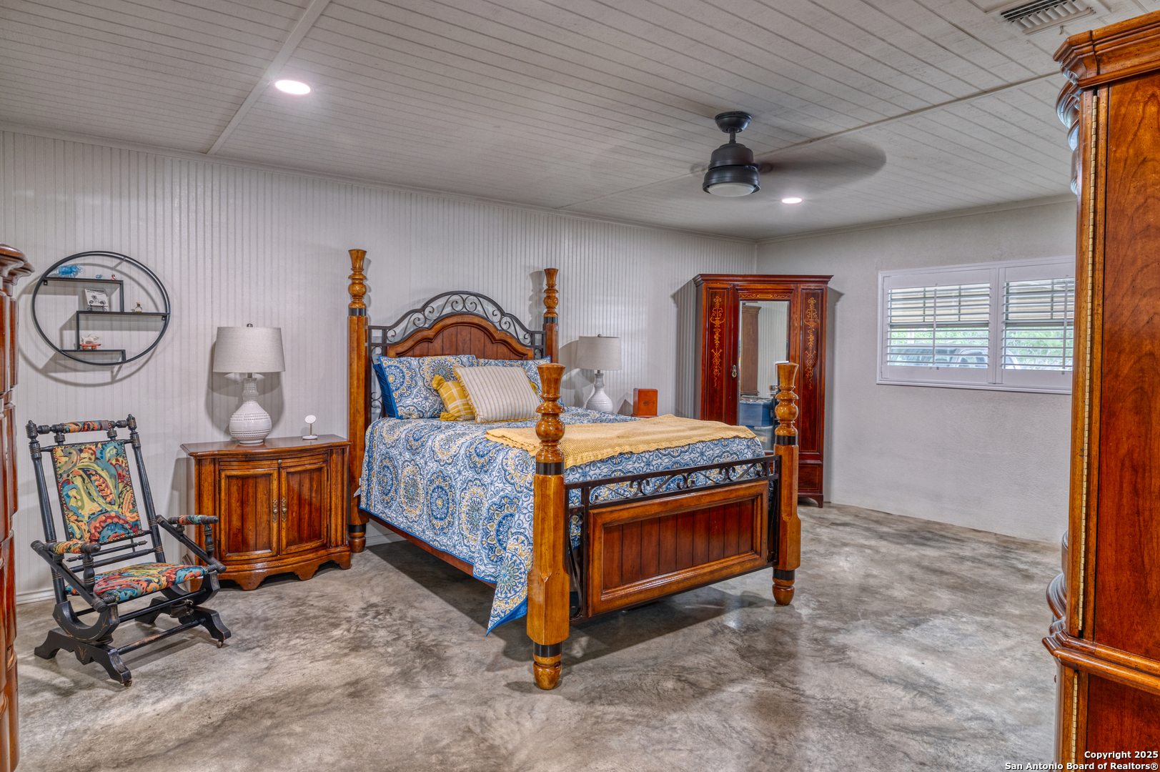 433 Mills Lane Uvalde, TX 78801 - Photo 12 of 51 a bedroom with a bed a dresser and windows