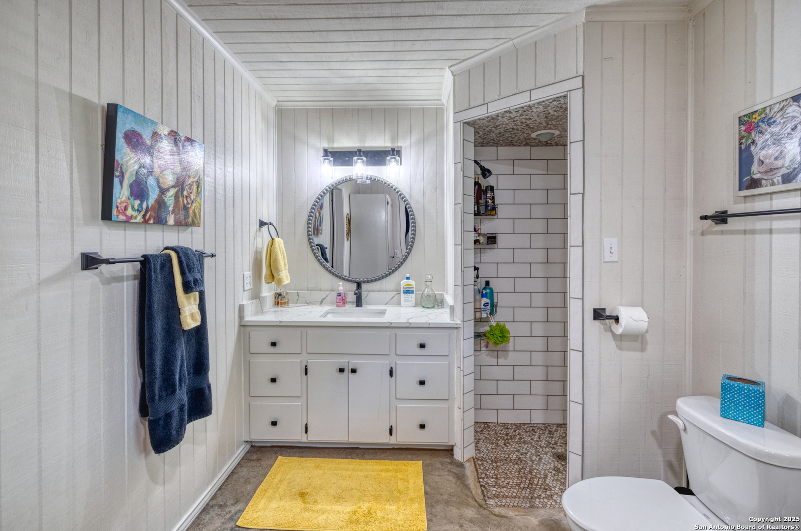 433 Mills Lane Uvalde, TX 78801 - Photo 13 of 51 a bathroom with a toilet a sink and a mirror