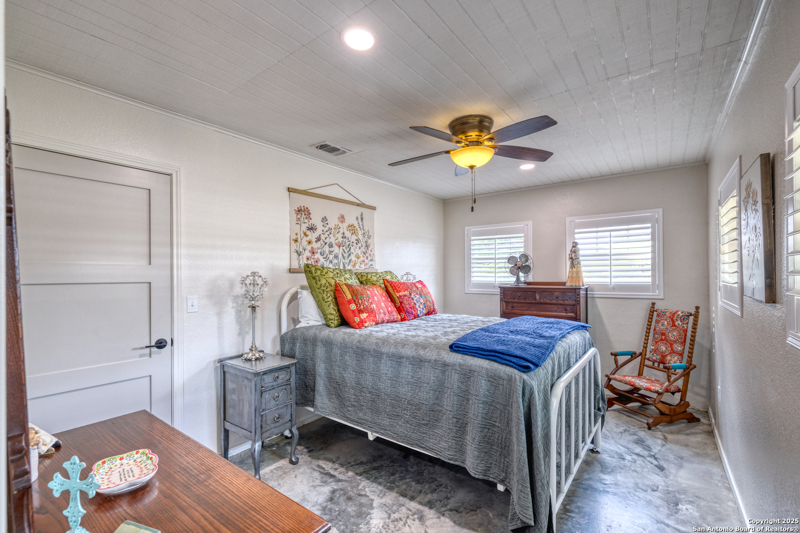433 Mills Lane Uvalde, TX 78801 - Photo 17 of 51 a bedroom with a bed and a chandelier
