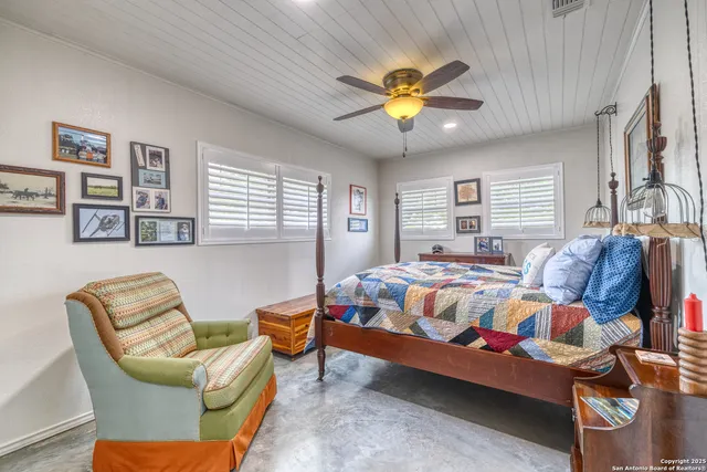 a bedroom with furniture and wooden floor