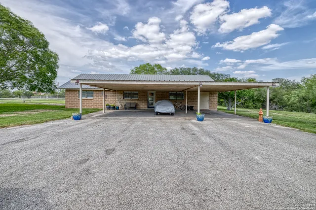 a view of a house with a yard and sitting area