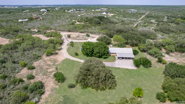 an aerial view of residential houses with outdoor space and garden