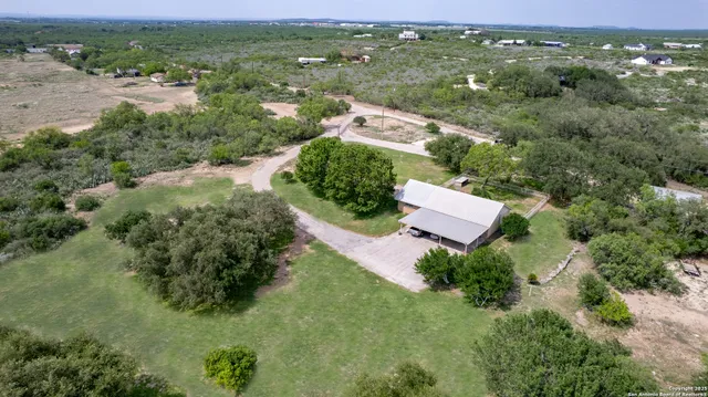 an aerial view of a house with a yard
