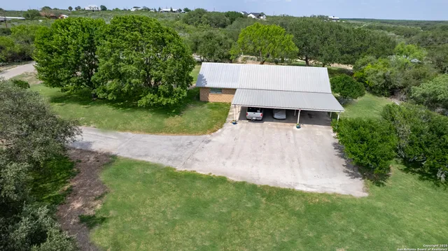 an aerial view of a house with yard