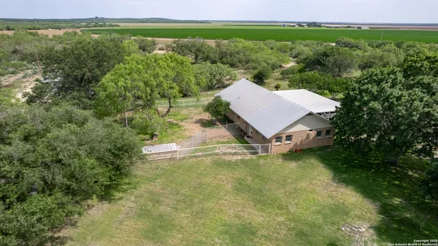 an aerial view of a house with a yard