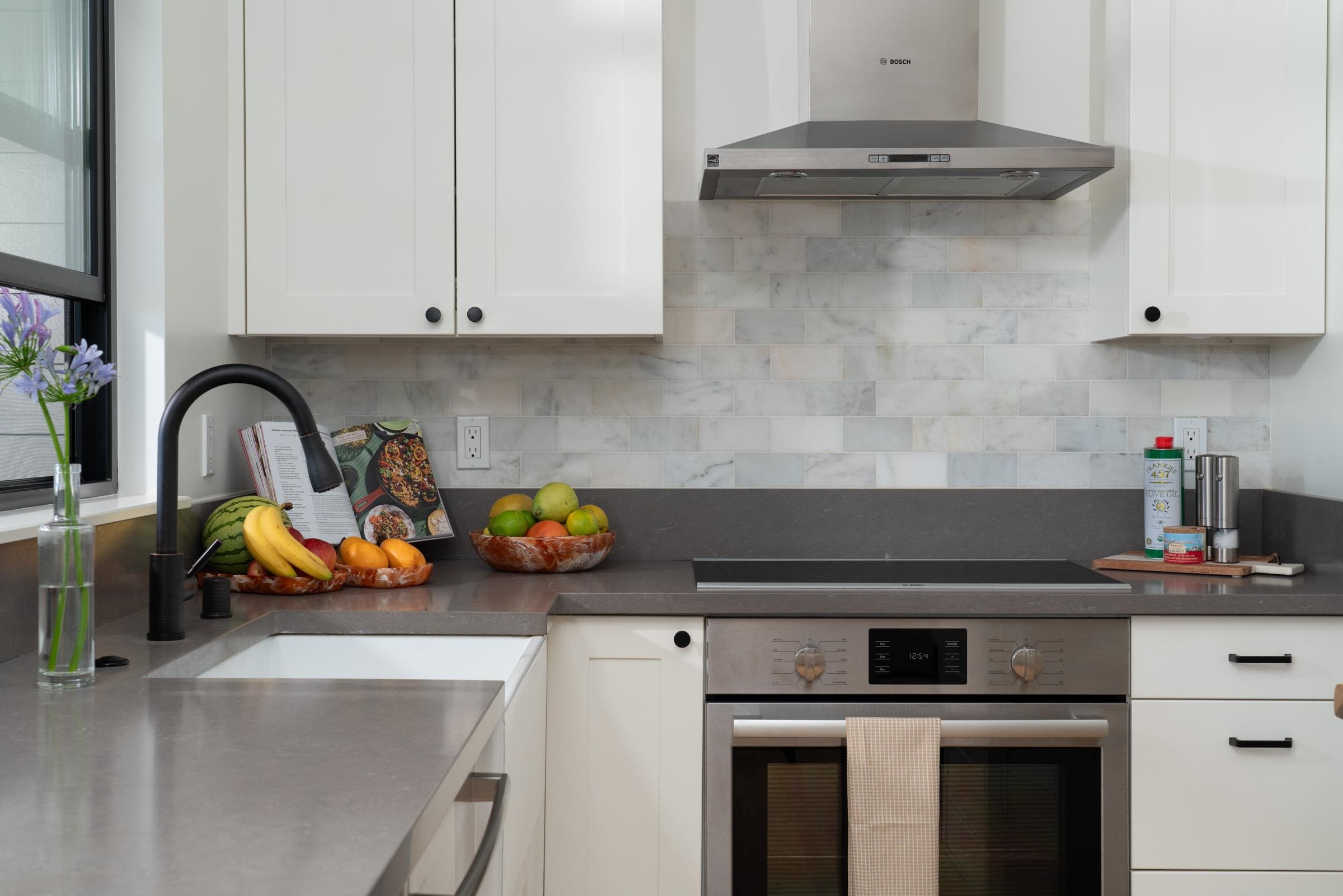 125 Hekuawa Street, Unit B Haiku, HI 96708 - Photo 14 of 50 a close view of a stove a sink and dishwasher in a kitchen