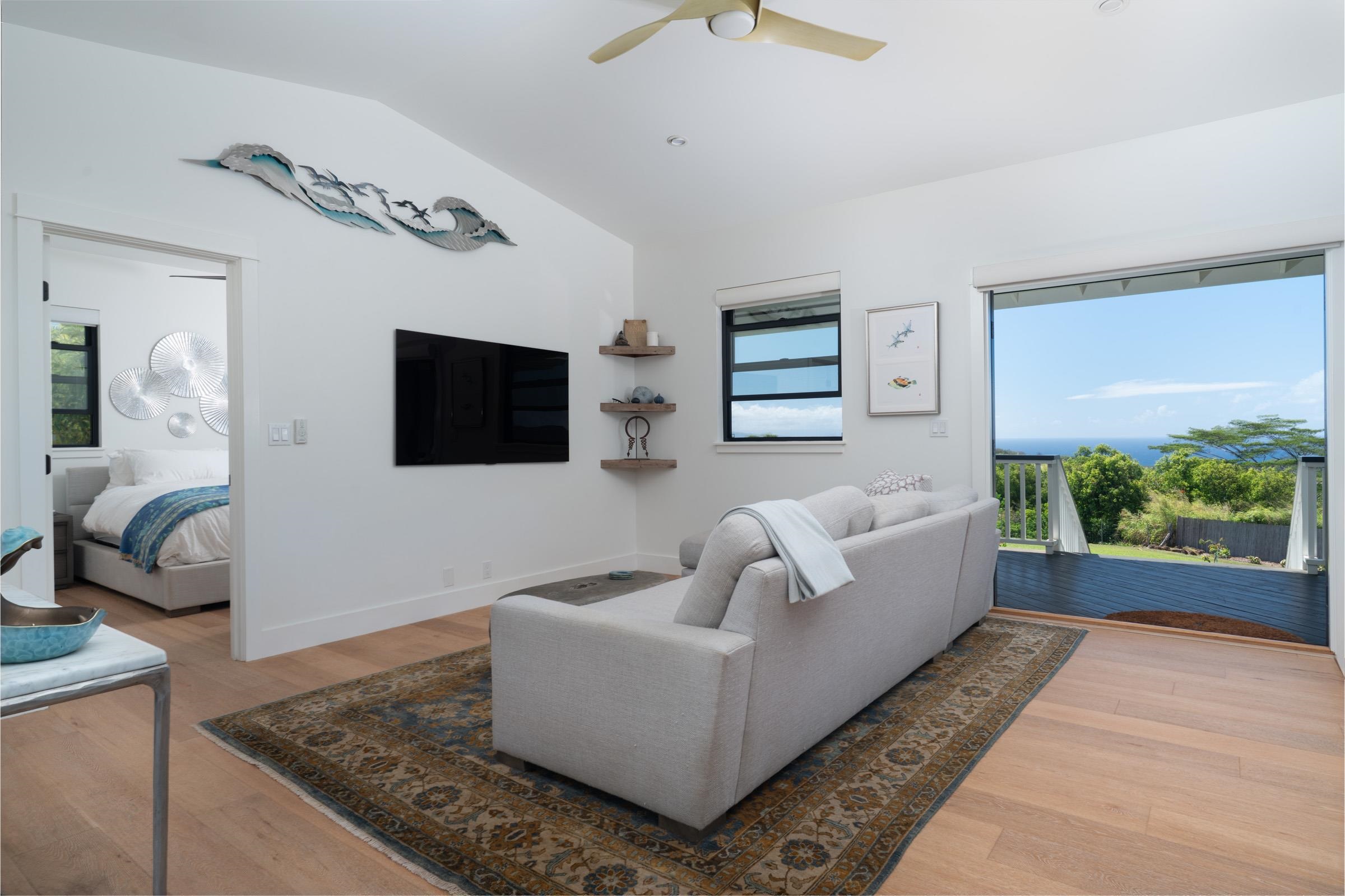125 Hekuawa Street, Unit B Haiku, HI 96708 - Photo 20 of 50 a living room with furniture and a flat screen tv