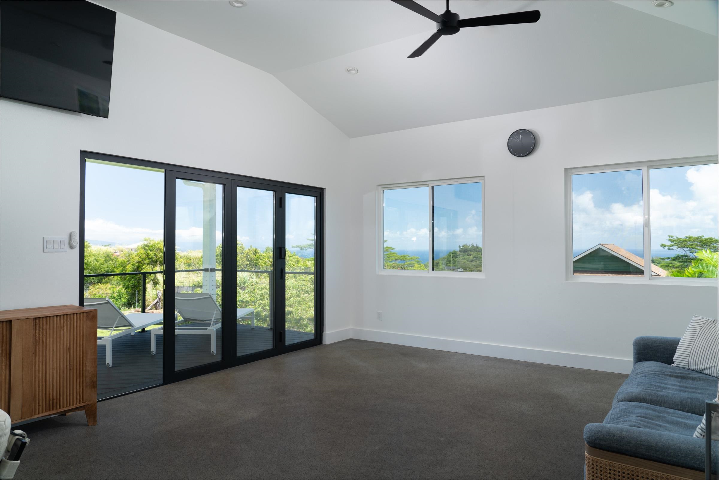 125 Hekuawa Street, Unit B Haiku, HI 96708 - Photo 34 of 50 a living room with furniture and a floor to ceiling window