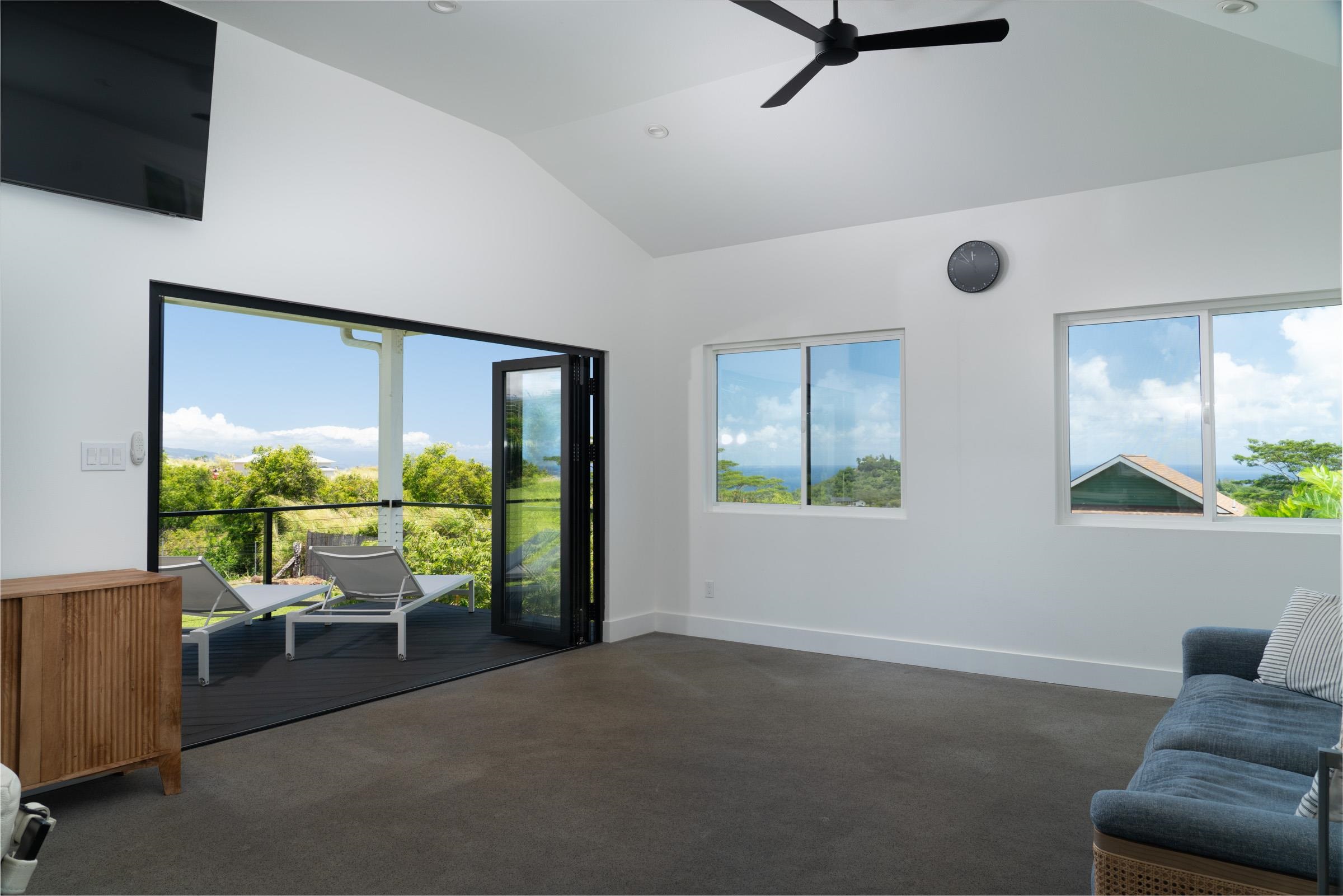 125 Hekuawa Street, Unit B Haiku, HI 96708 - Photo 37 of 50 a living room with furniture and a floor to ceiling window