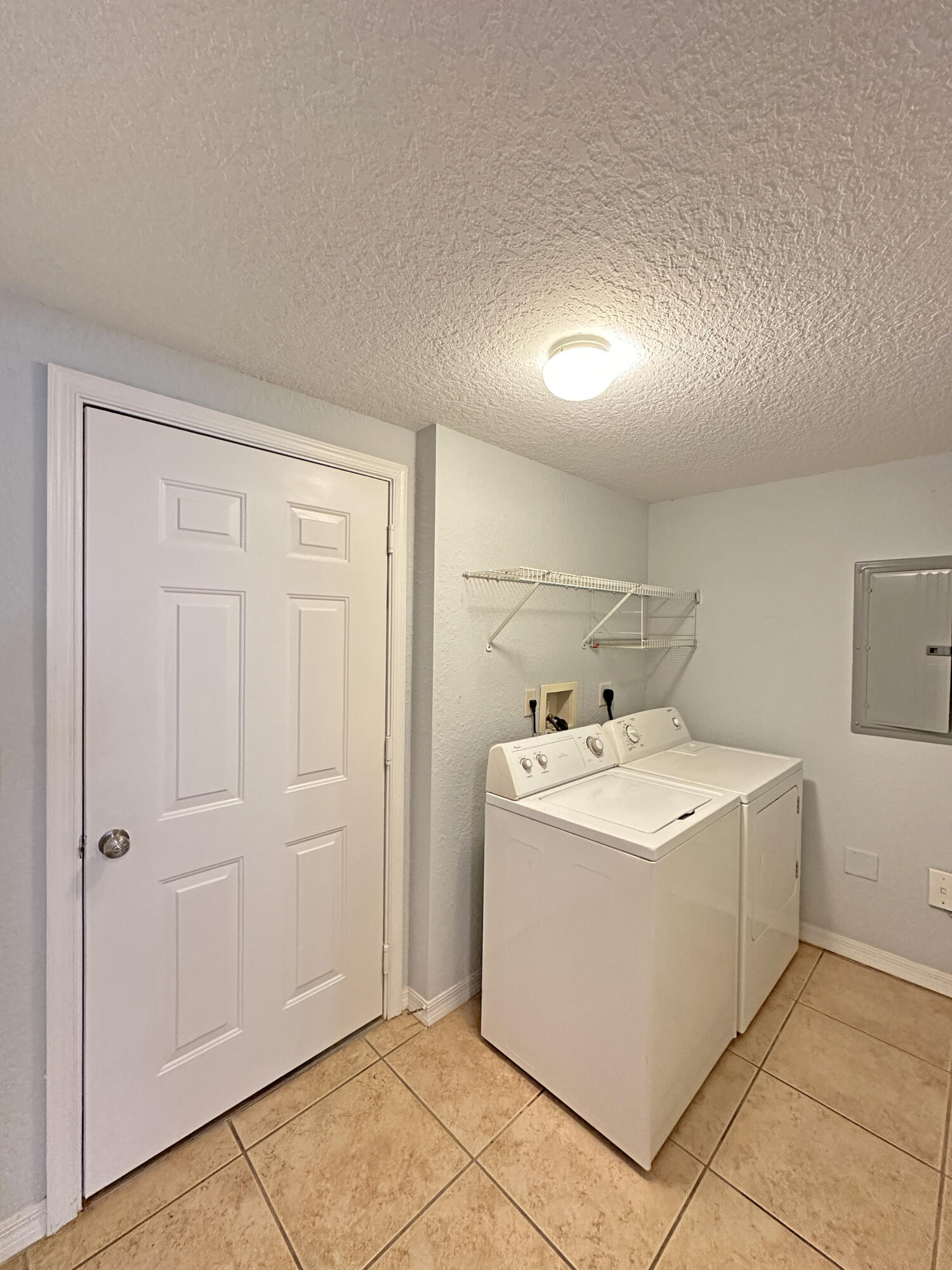 144 Southwest Peacock Boulevard, Unit 101 Port St. Lucie, FL 34986 - Photo 26 of 52 a utility room with dryer and washer