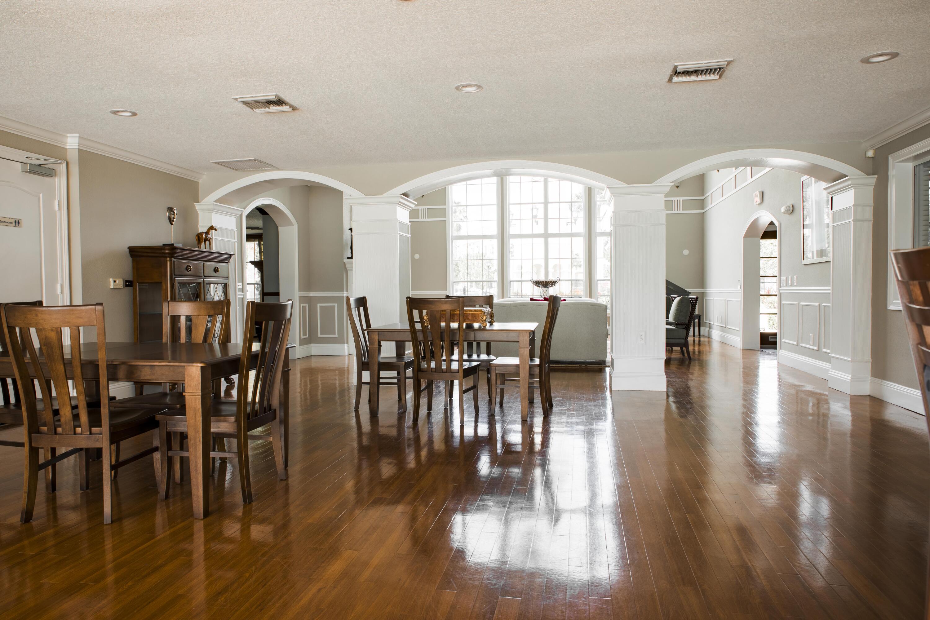 144 Southwest Peacock Boulevard, Unit 101 Port St. Lucie, FL 34986 - Photo 39 of 52 a view of a a dining room with furniture window and wooden floor