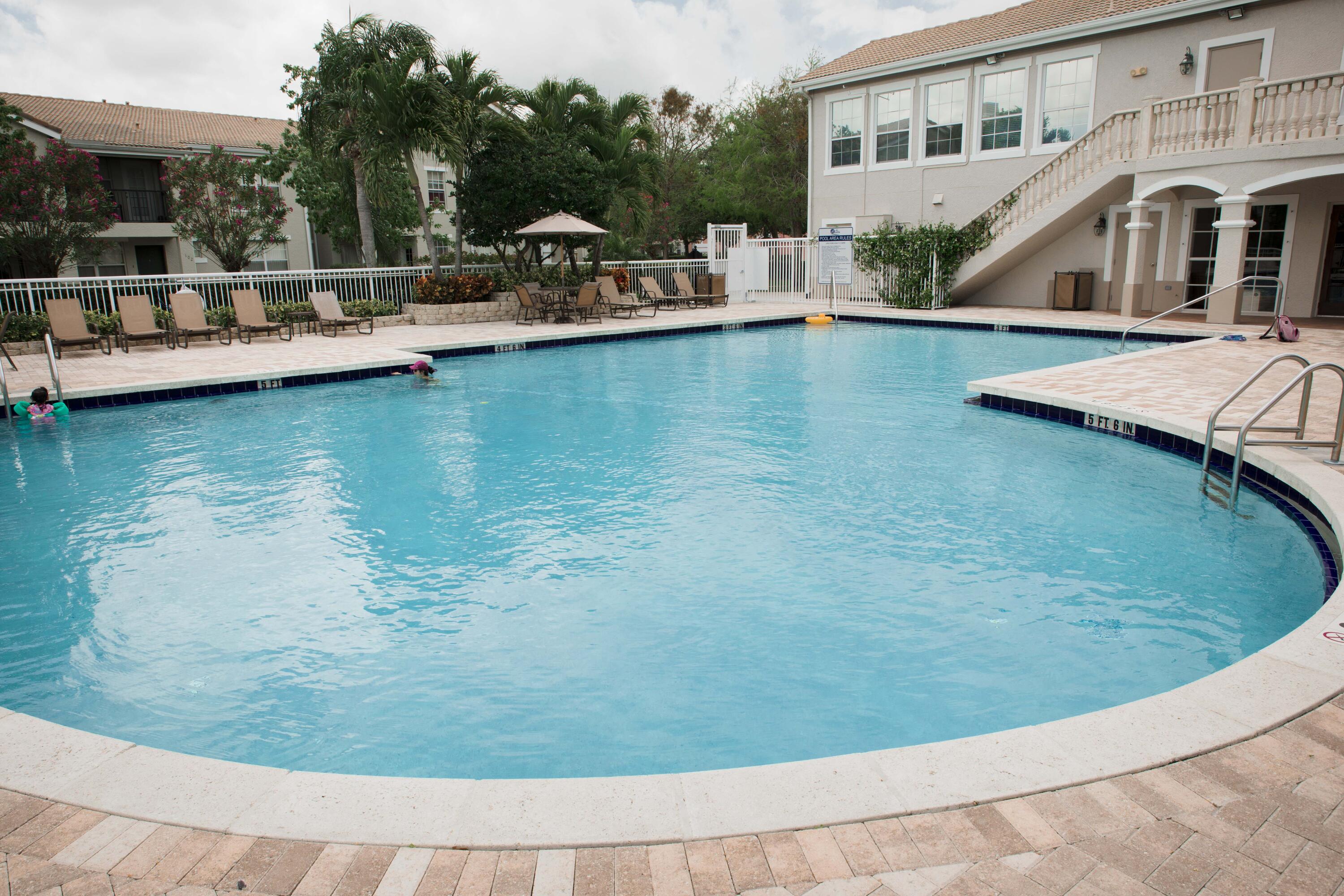 144 Southwest Peacock Boulevard, Unit 101 Port St. Lucie, FL 34986 - Photo 49 of 52 a view of a house with pool porch and sitting area