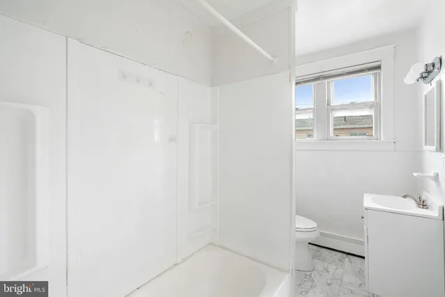 a bathroom with a toilet a sink and shower