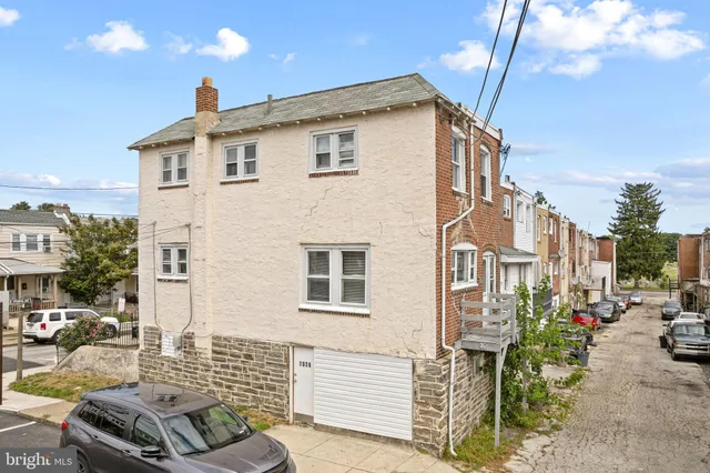 a view of a patio with table and chairs with wooden fence