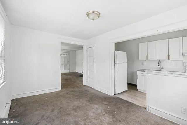 a view of a kitchen with a sink and a refrigerator