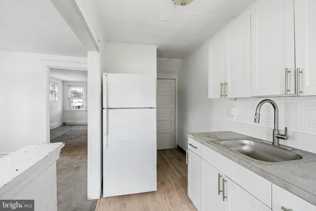 a kitchen with a sink and a refrigerator