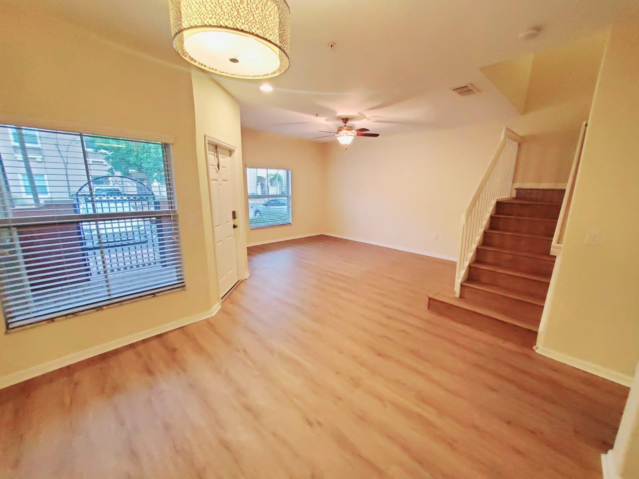 2851 Prospect Road Tamarac, FL 33309 - Photo 1 of 21 a view of an empty room with wooden floor and a window