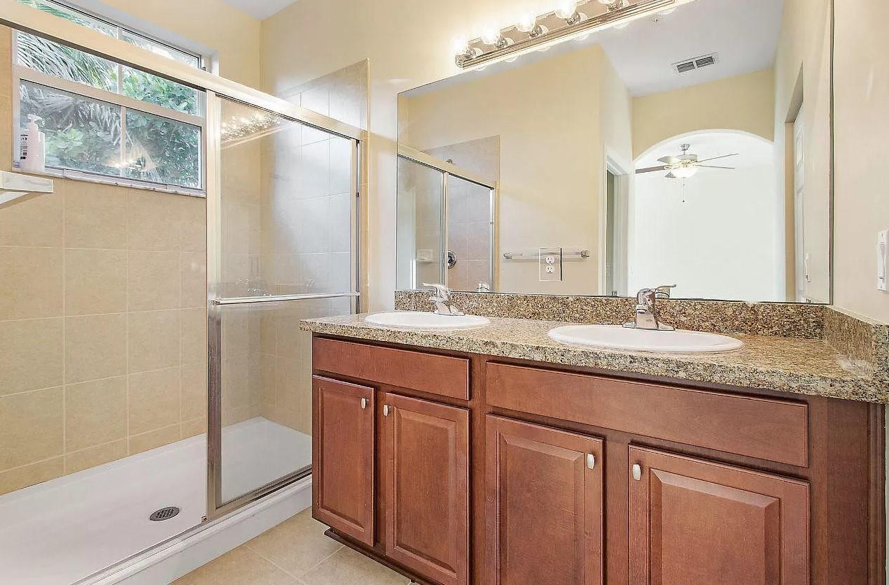 2851 Prospect Road Tamarac, FL 33309 - Photo 13 of 21 a bathroom with a granite countertop sink and a mirror