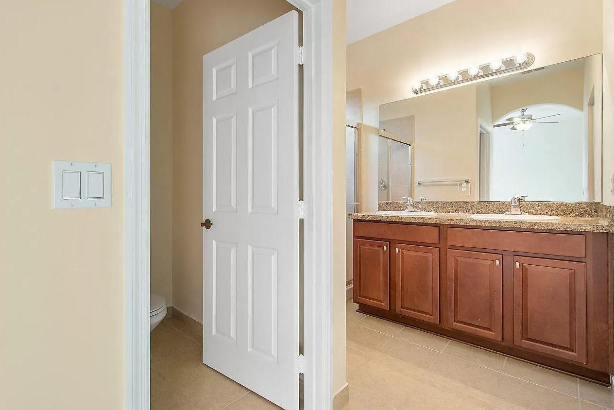 2851 Prospect Road Tamarac, FL 33309 - Photo 14 of 21 a en suite bathroom with a granite countertop sink and a mirror