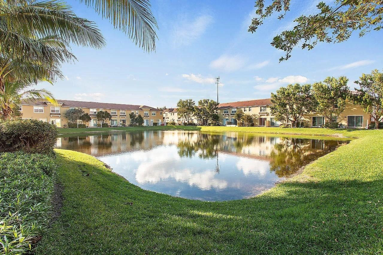 2851 Prospect Road Tamarac, FL 33309 - Photo 20 of 21 a view of a lake with houses in the back