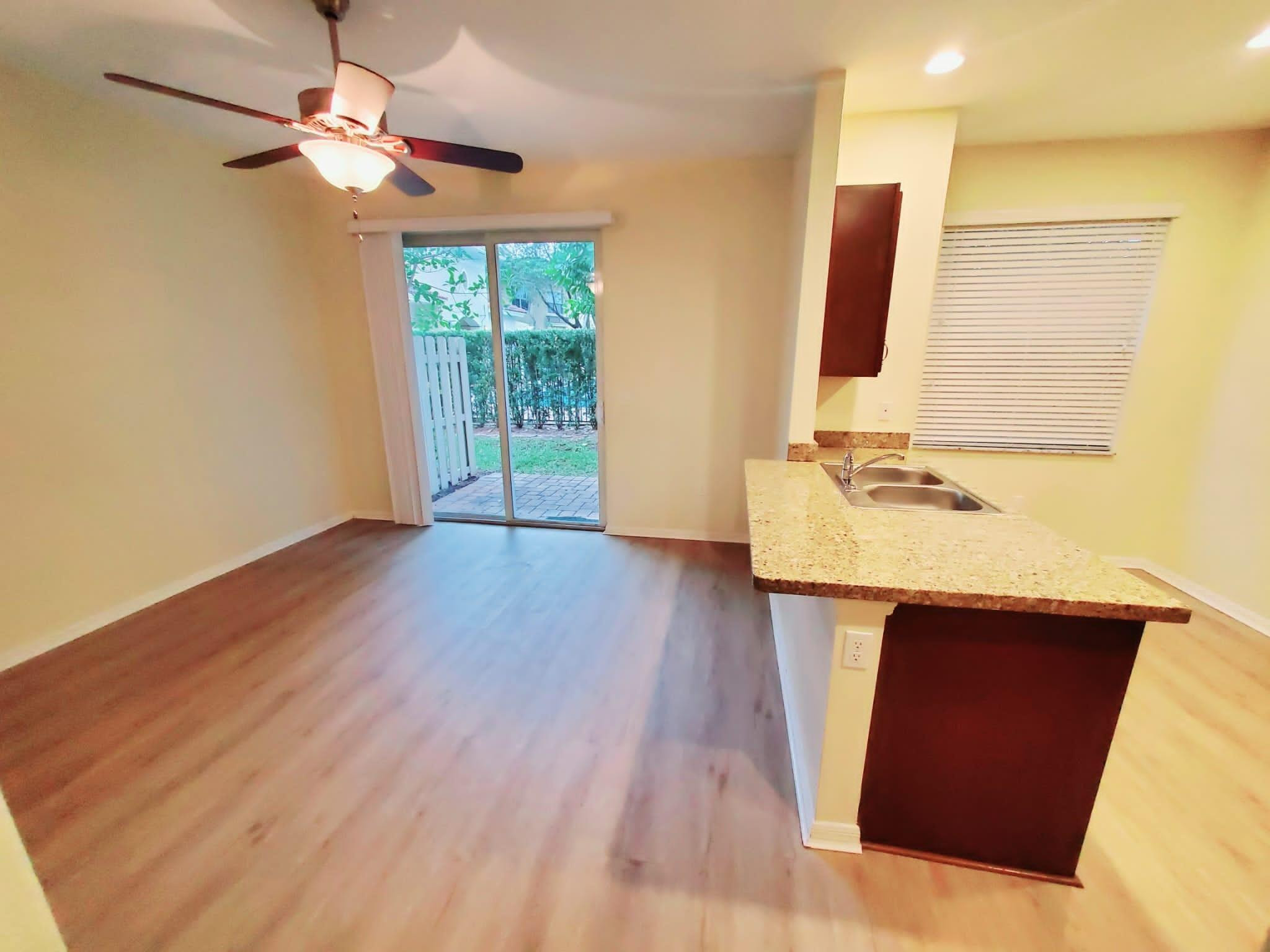 2851 Prospect Road Tamarac, FL 33309 - Photo 4 of 21 a view of kitchen with wooden floor and window