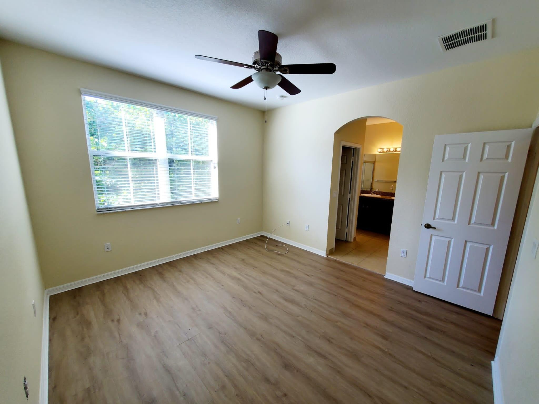 2851 Prospect Road Tamarac, FL 33309 - Photo 6 of 21 a view of empty room with wooden floor and fan