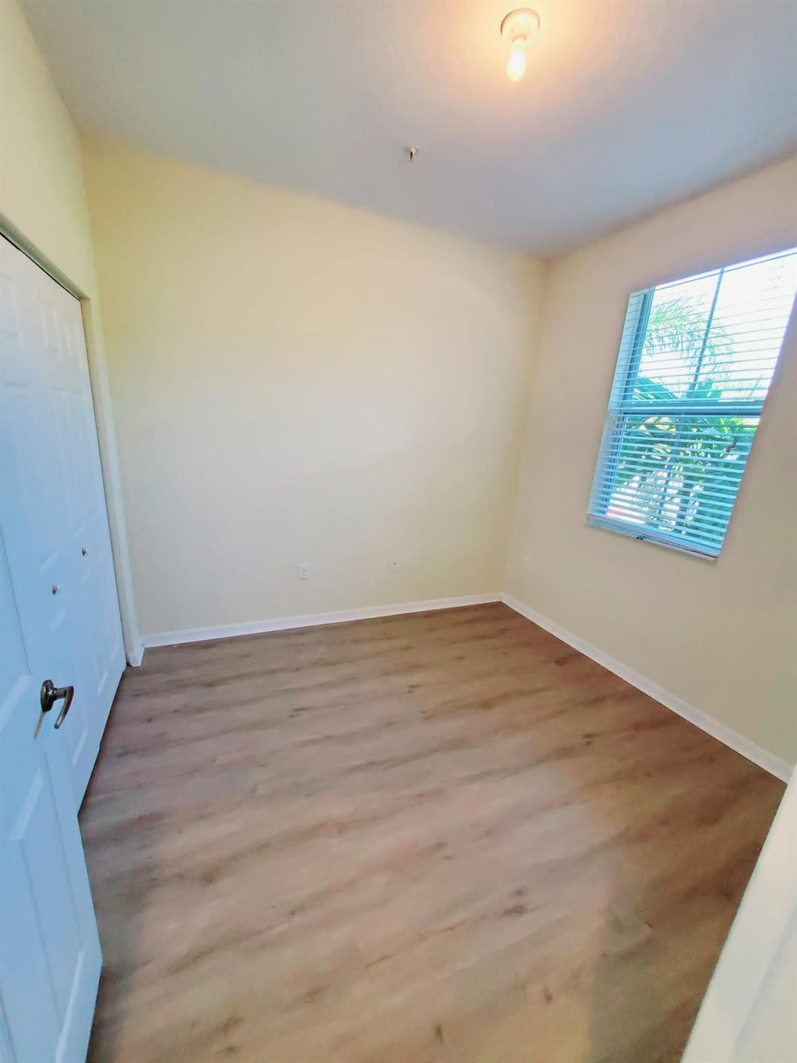 2851 Prospect Road Tamarac, FL 33309 - Photo 9 of 21 a view of a room with wooden floor and window
