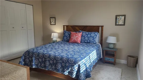 a large bed sitting in a bedroom next to a lamp