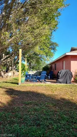a view of a house with a yard and sitting area