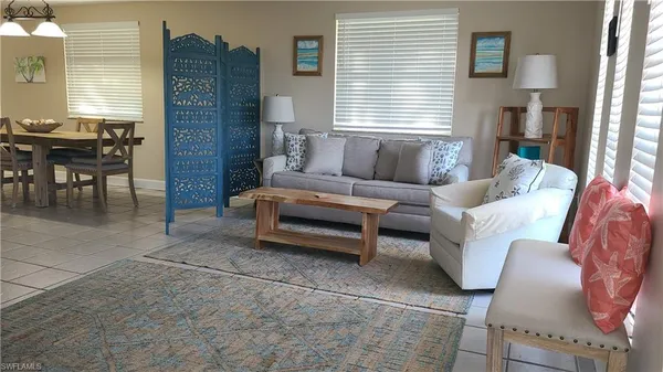 a living room with furniture a fireplace and a window