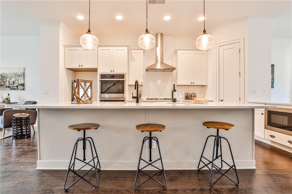 410 Hargrove Lane Decatur, GA 30030 - Photo 1 of 1 a kitchen with stainless steel appliances kitchen island a large white counter space and wooden floor