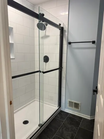 a bathroom with a glass shower door