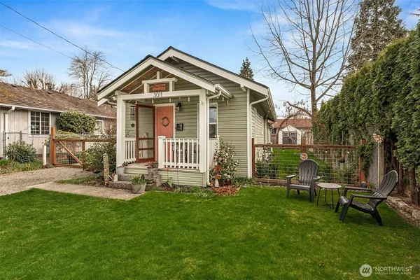 a view of a house with a yard and sitting area