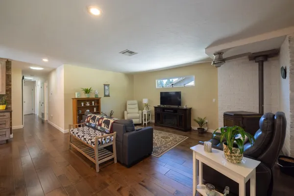 a living room with furniture rug and a flat screen tv
