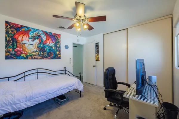 a bedroom with bed and a chandelier