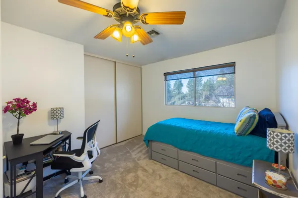 a bedroom with a bed and a table in it