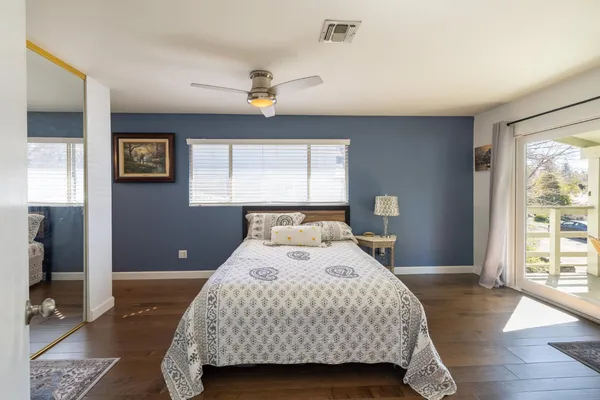 a bedroom with a bed and wooden floor