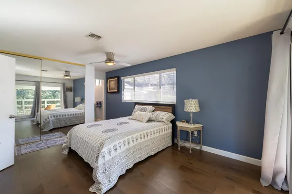 a bedroom with a bed and a large window