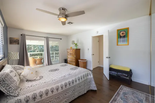 a bedroom with a bed a couch and a window