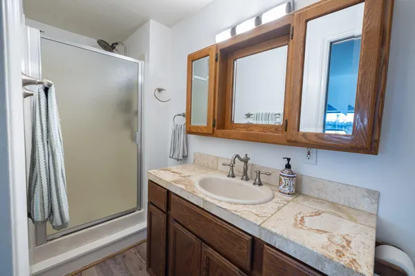 a kitchen with granite countertop a sink a stove and refrigerator