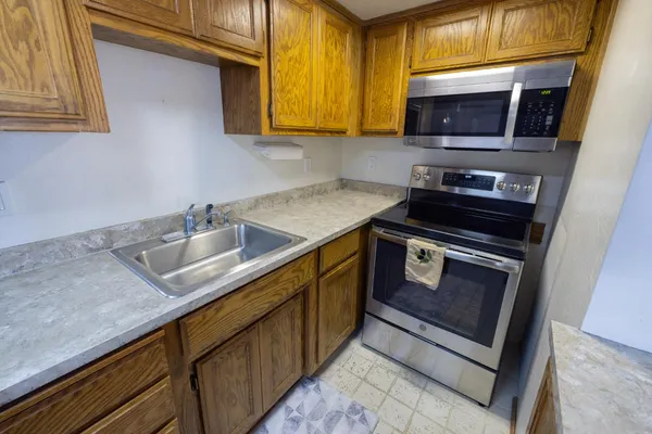 a kitchen with granite countertop a sink and stove