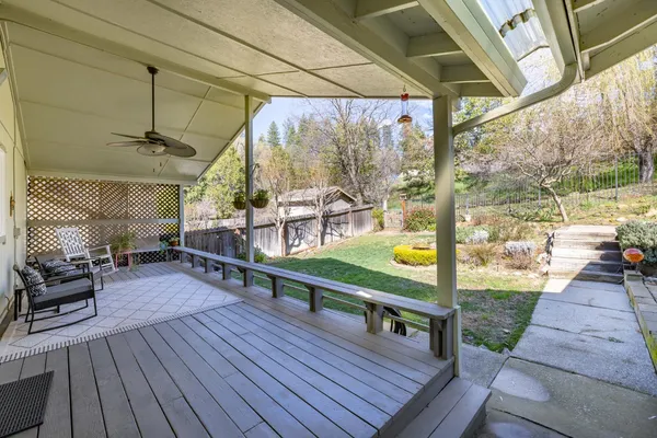 a view of a house with backyard and sitting area