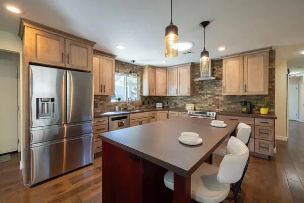 a kitchen with a refrigerator a stove a sink and a refrigerator