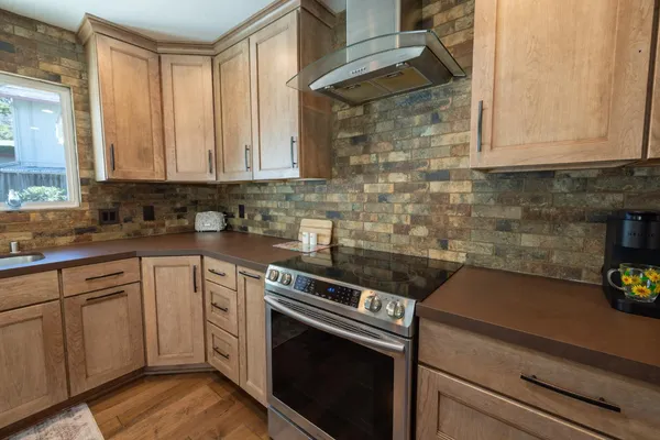 a kitchen with a sink stove and cabinets