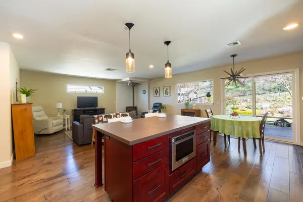 a large kitchen with a table and chairs