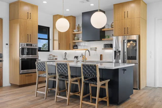 a kitchen with a dining table cabinets and chairs