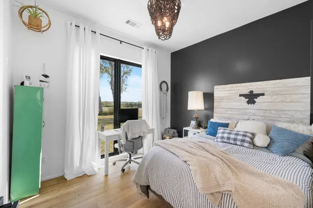 a bedroom with a bed and a window